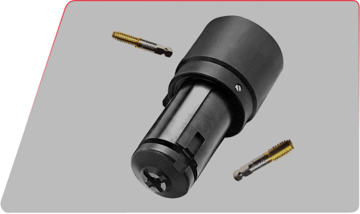 Industrial tap chuck tool holder with two golden threading taps floating nearby against a gray background.