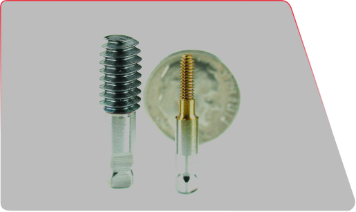 Two industrial threaded drill taps of different sizes placed in front of a dime for scale.