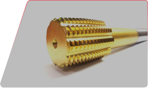 Close-up of a gold-colored metal reamer tool with serrated flutes and a central pilot hole.