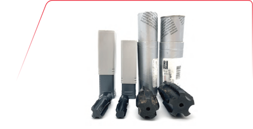 Four metal machining reamers with their respective grey plastic protective storage containers on a white background.