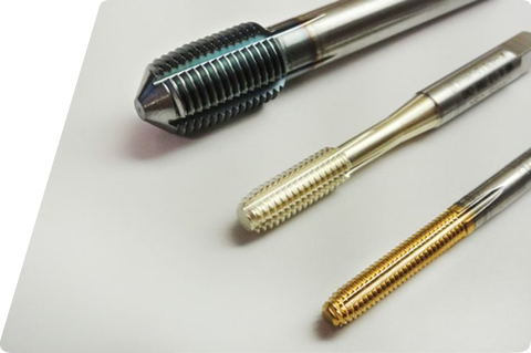 Three different metal cutting taps arranged diagonally on a white background.