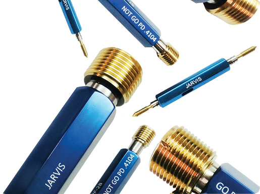 Several Jarvis brand blue handle thread plug gauges with brass and steel ends on a white background.